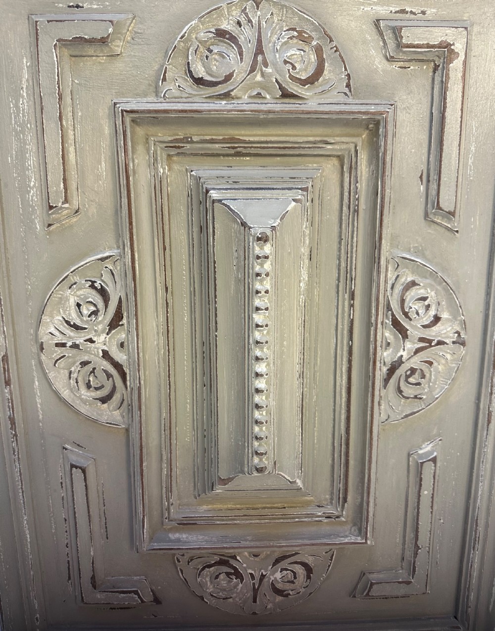 A pair of rectangular French hand-carved wooden panels featuring raised geometric mouldings, relief scrolls, and a distressed grey painted finish. View VII