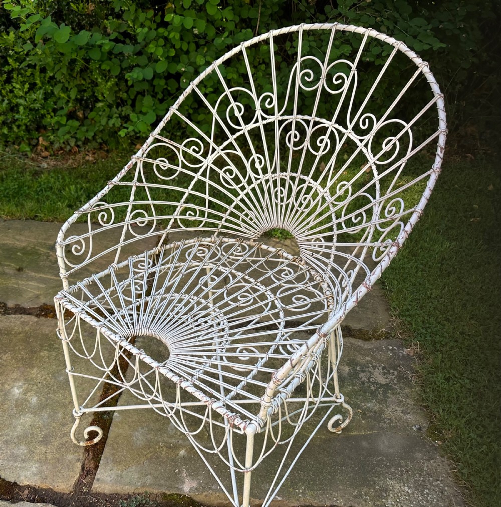 A three-piece white painted wrought iron wirework garden set featuring a bench and two matching armchairs with arched fan-back designs. View II