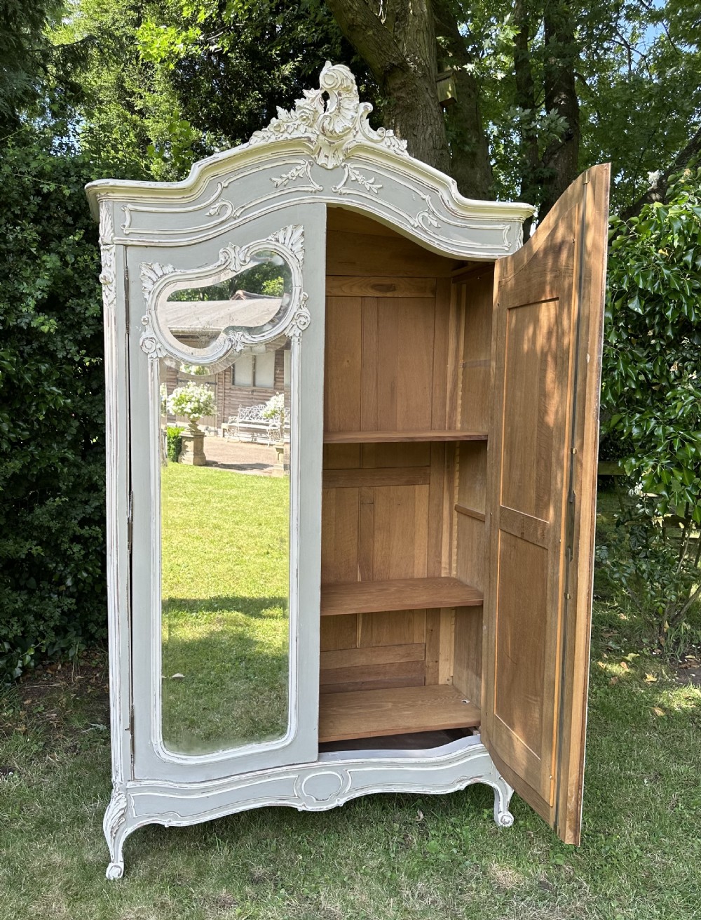 A grey and off-white painted French armoire featuring double mirrored doors and an ornate carved Rococo cresting. View VIII