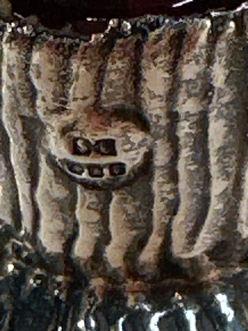A patterned red glass perfume bottle featuring an embossed Irish silver collar and a round clear glass stopper. View IV