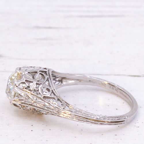 An Art Deco solitaire ring featuring an old European cut diamond set in an intricately carved filigree silver-coloured band. View IV