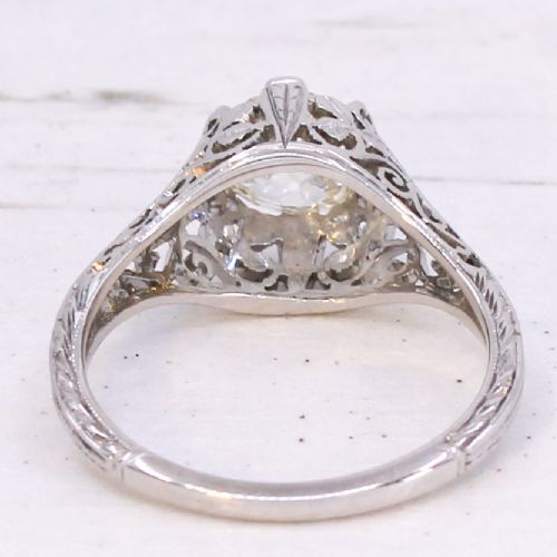 An Art Deco solitaire ring featuring an old European cut diamond set in an intricately carved filigree silver-coloured band. View V