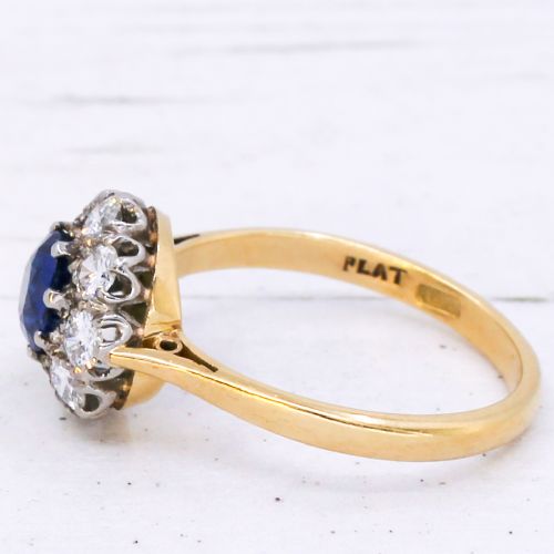 fig 3. A yellow gold vintage ring featuring a central round blue sapphire encircled by a halo of brilliant-cut diamonds.