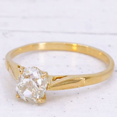 An Edwardian yellow gold solitaire ring featuring a claw-set old cut diamond on a slender band.