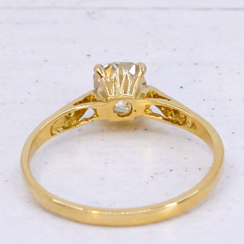 An Edwardian yellow gold solitaire ring featuring a claw-set old cut diamond on a slender band. View V