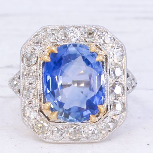 fig 2. An antique Edwardian cluster ring featuring a central cushion-cut blue Ceylon sapphire surrounded by a halo of diamonds set in platinum and yellow gold.