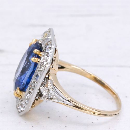fig 3. An antique Edwardian cluster ring featuring a central cushion-cut blue Ceylon sapphire surrounded by a halo of diamonds set in platinum and yellow gold.