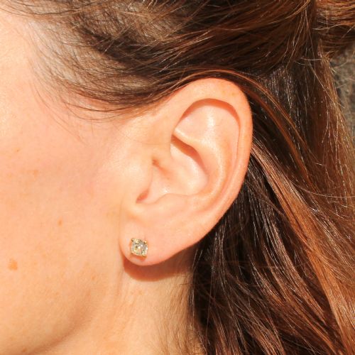 fig 1. A pair of 18k yellow gold stud earrings featuring claw-set old mine cut cushion diamonds.
