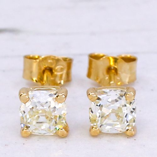 fig 2. A pair of 18k yellow gold stud earrings featuring claw-set old mine cut cushion diamonds.