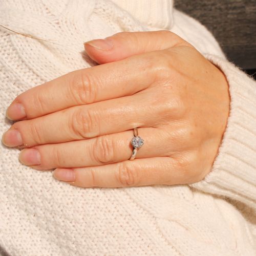 fig 1. A vintage silver-toned engagement ring featuring a single old cut diamond in a multi-claw setting.