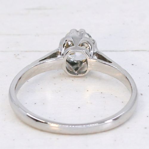 A vintage silver-toned engagement ring featuring a single old cut diamond in a multi-claw setting. View V