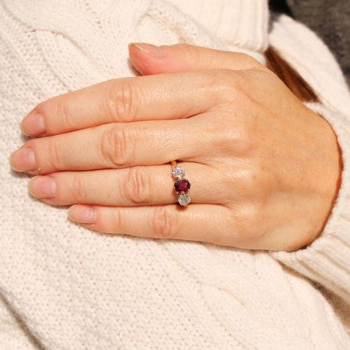fig 1. An antique yellow gold trilogy ring featuring a central cushion-cut red ruby flanked by two old-cut diamonds in claw settings.