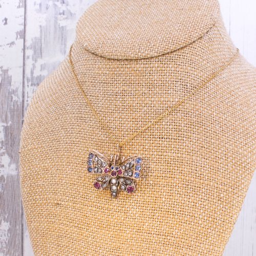 fig 3. A Victorian butterfly brooch set with rubies, sapphires, diamonds, and natural pearls in silver and gold.
