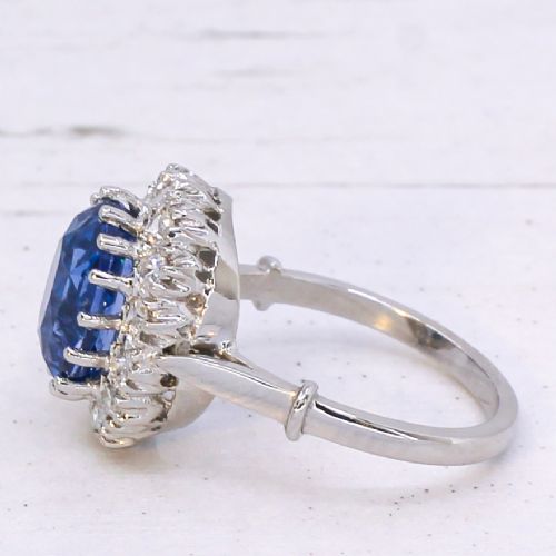 fig 3. An oval blue Ceylon sapphire encircled by a halo of brilliant diamonds set on a silver metal band.