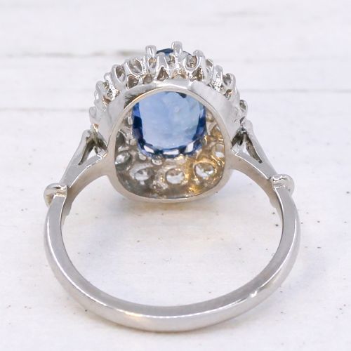 fig 4. An oval blue Ceylon sapphire encircled by a halo of brilliant diamonds set on a silver metal band.