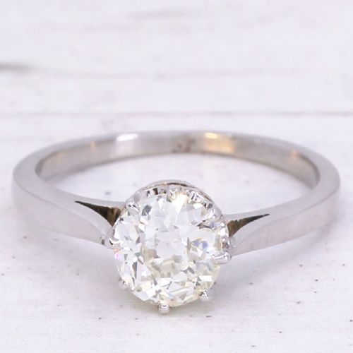 fig 2. A solitaire ring featuring a 0.94-carat old-cut diamond mounted in a multi-claw setting on a polished silver-tone band.