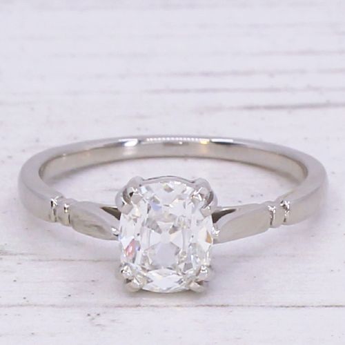 fig 2. A platinum vintage ring featuring a central cushion-shaped old cut diamond held in a multi-claw setting with detailed shoulders.