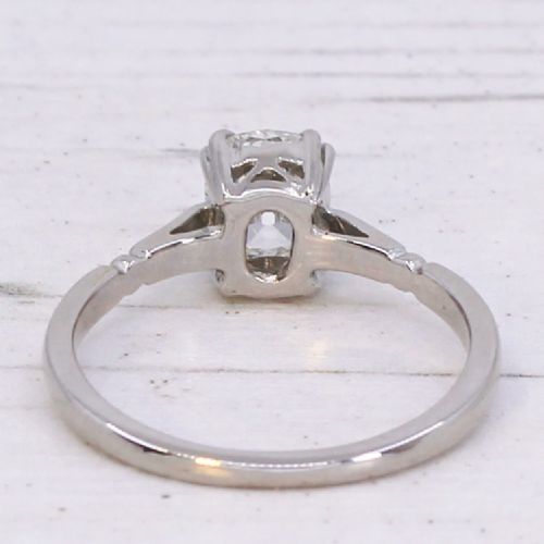 A platinum vintage ring featuring a central cushion-shaped old cut diamond held in a multi-claw setting with detailed shoulders. View V