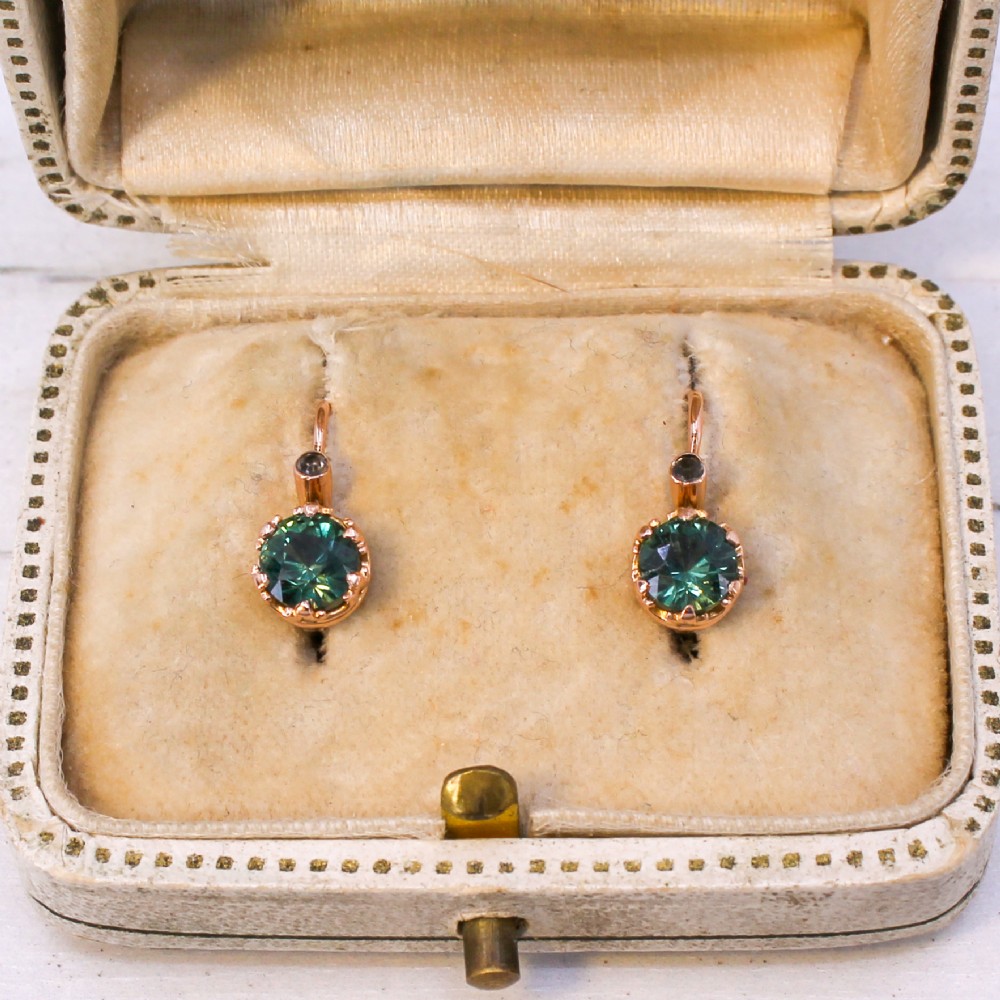 A pair of late Victorian rose gold drop earrings set with circular brilliant teal sapphires in crown claw mountings with leverback fittings. View IV