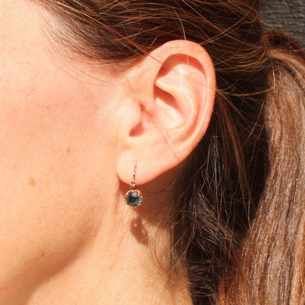 A pair of late Victorian rose gold drop earrings set with circular brilliant teal sapphires in crown claw mountings with leverback fittings. View X
