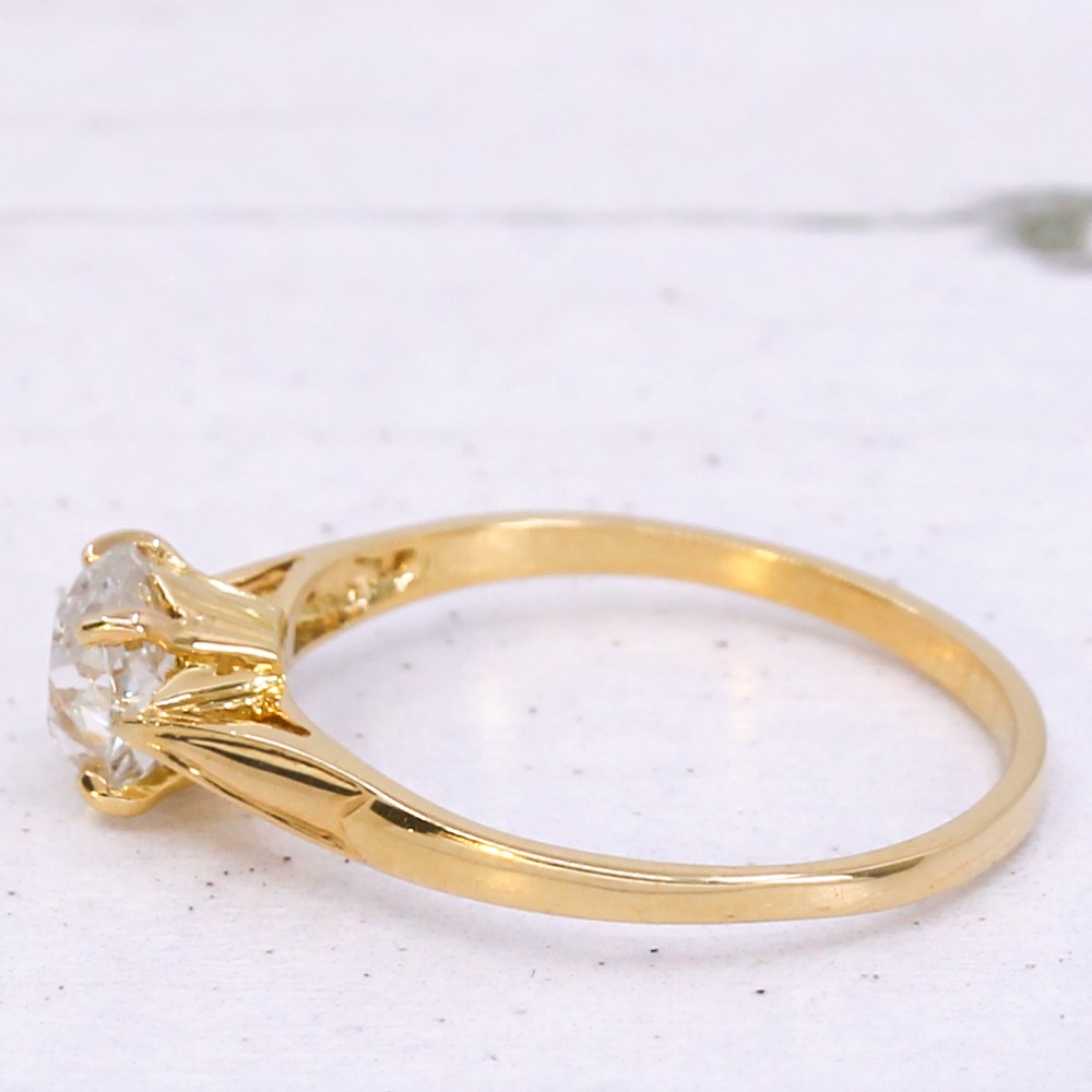 An Edwardian yellow gold solitaire ring featuring a claw-set old cut diamond on a slender band. View IV