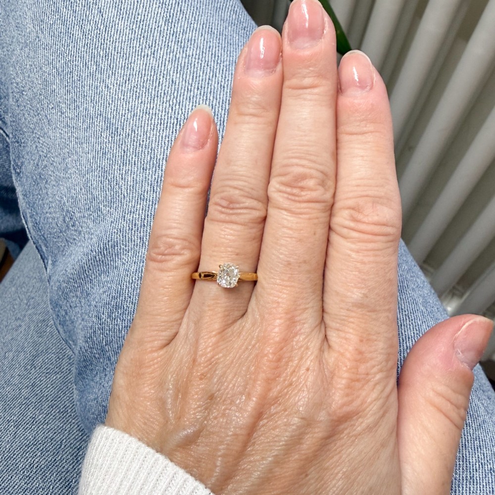 An Edwardian yellow gold solitaire ring featuring a claw-set old cut diamond on a slender band. View VI