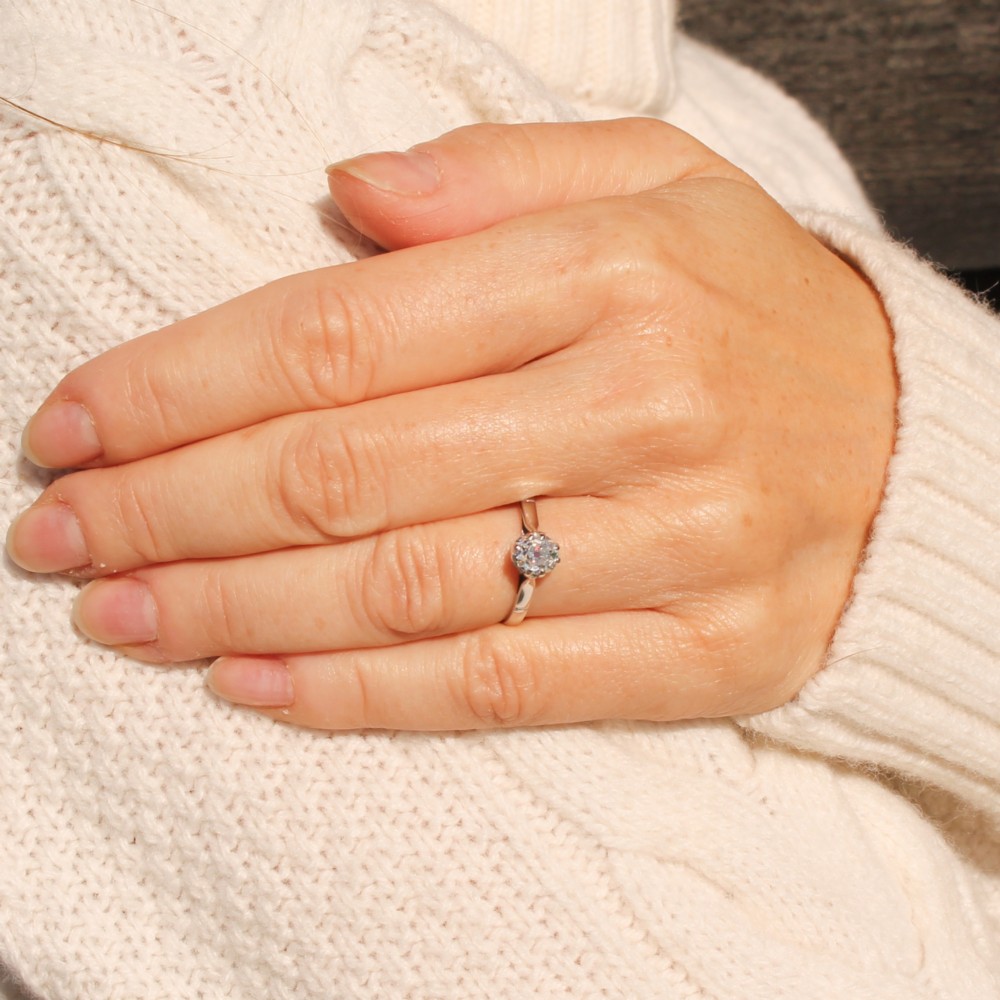 A vintage silver-toned engagement ring featuring a single old cut diamond in a multi-claw setting. View II