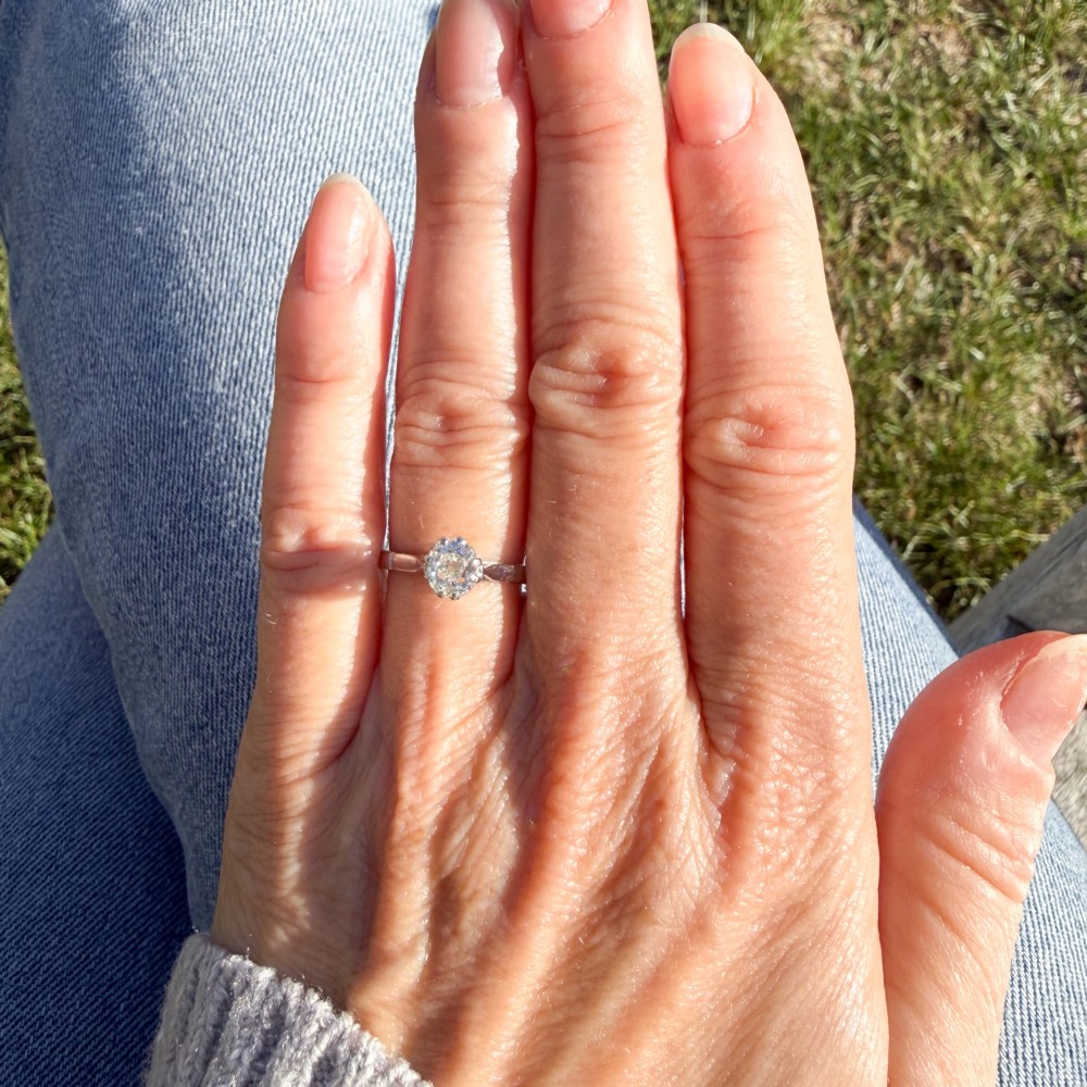 A vintage silver-toned engagement ring featuring a single old cut diamond in a multi-claw setting. View VII