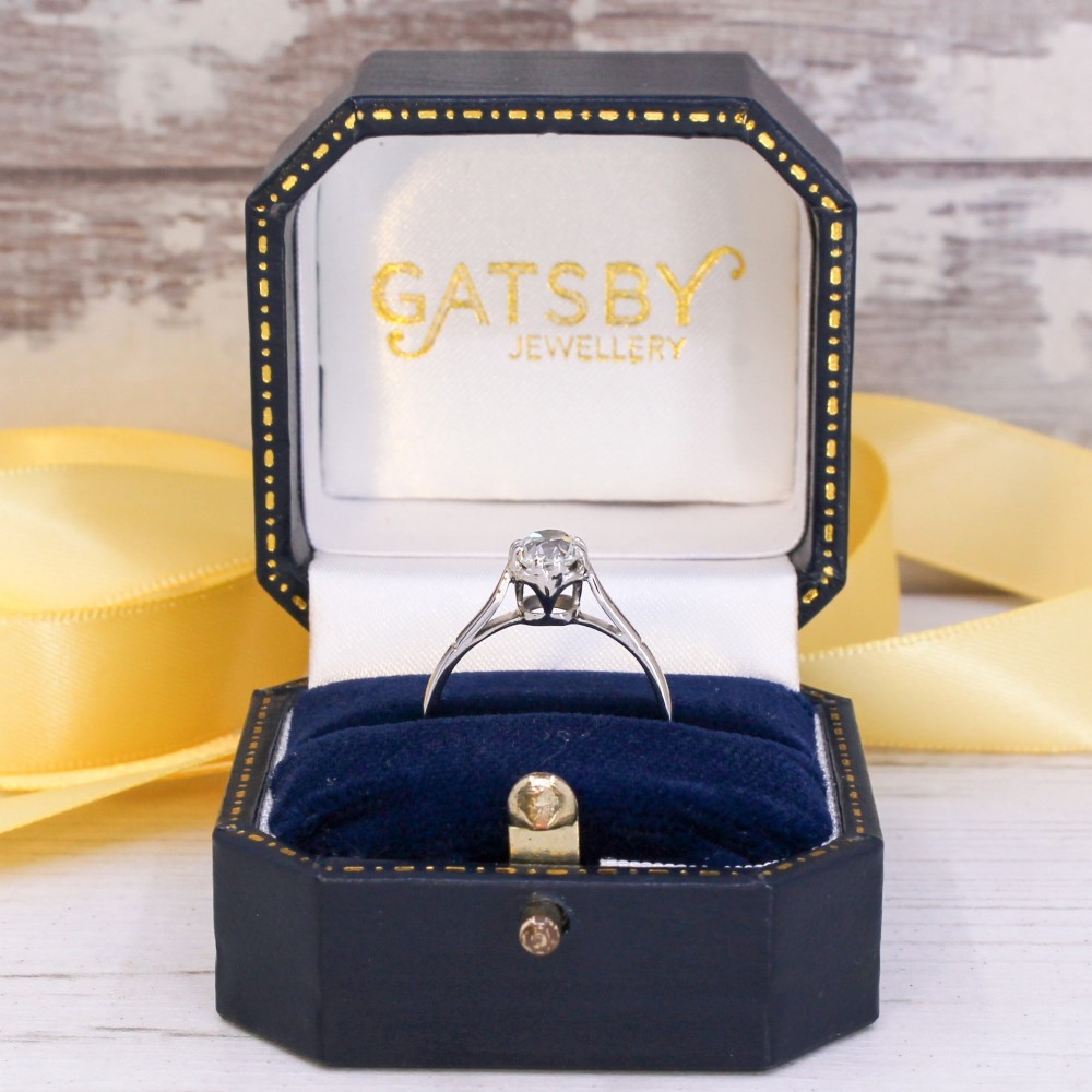 A vintage silver-toned engagement ring featuring a single old cut diamond in a multi-claw setting. View IX