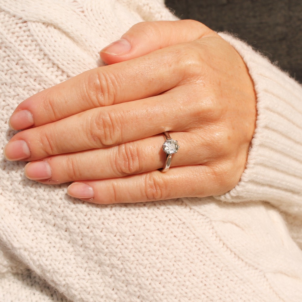 A solitaire ring featuring a 0.94-carat old-cut diamond mounted in a multi-claw setting on a polished silver-tone band. View VI