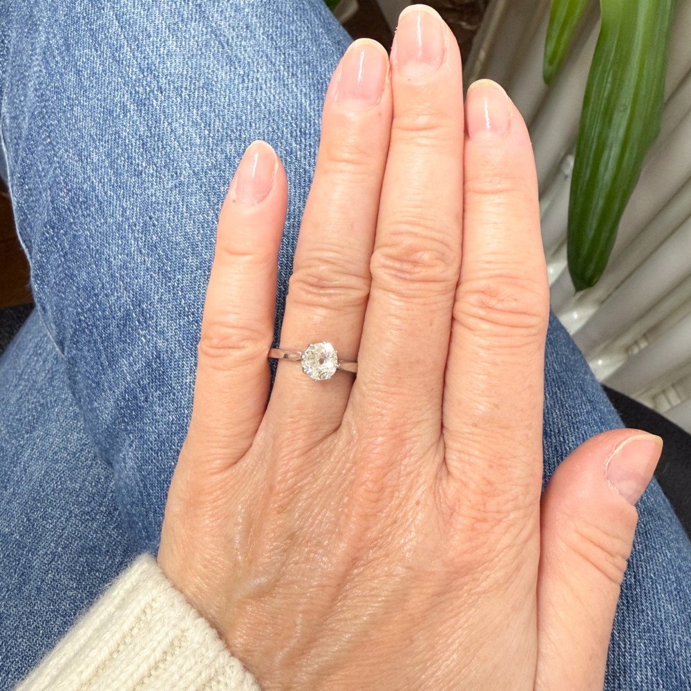 A solitaire ring featuring a 0.94-carat old-cut diamond mounted in a multi-claw setting on a polished silver-tone band. View VII
