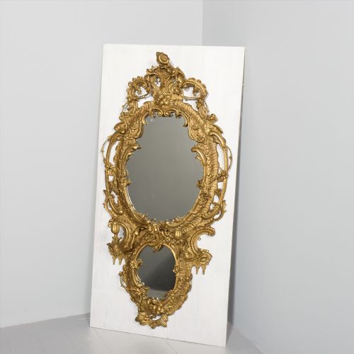 A LARGE CARVED AND GILDED ROCOCO MIRROR
