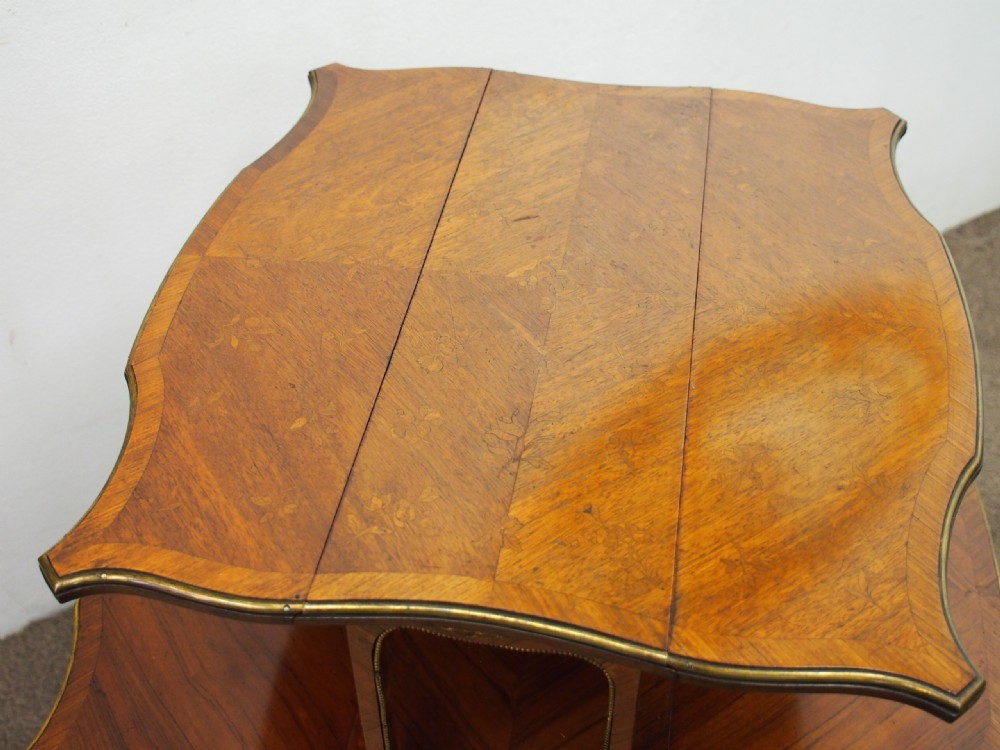 A double-tiered warm brown walnut Sutherland tea table featuring drop leaves, brass mounts, and cabriole legs. View VI