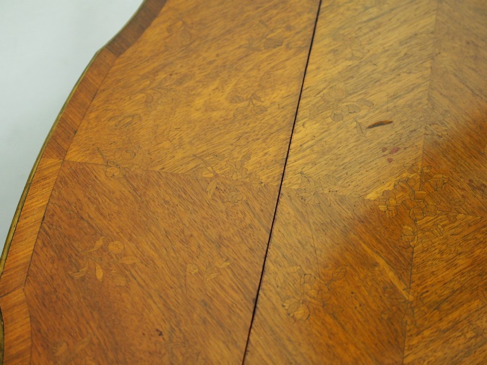 A double-tiered warm brown walnut Sutherland tea table featuring drop leaves, brass mounts, and cabriole legs. View VII