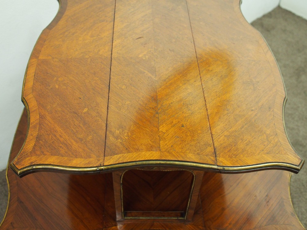 A double-tiered warm brown walnut Sutherland tea table featuring drop leaves, brass mounts, and cabriole legs. View VIII