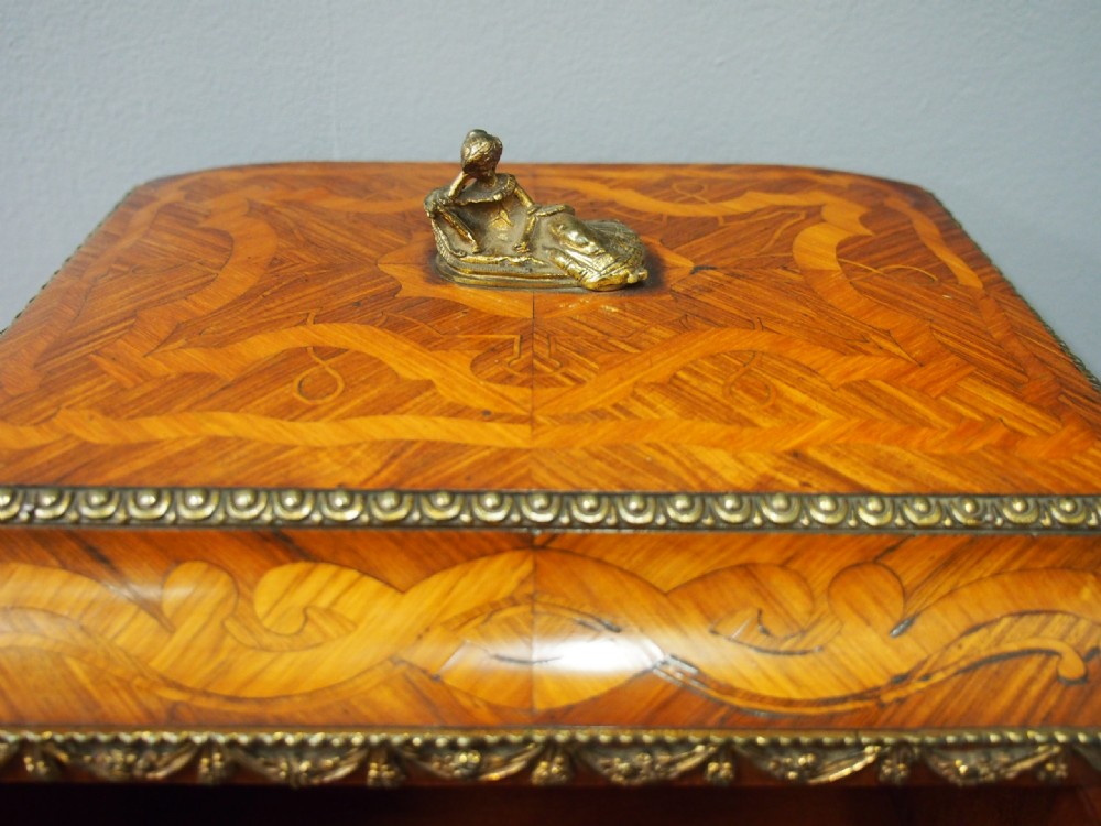 A French Rococo Revival ladies writing desk featuring intricate wood marquetry, gilt-bronze mounts, cabriole legs, and a central cabinet door set with a hand-painted porcelain plaque. View VII