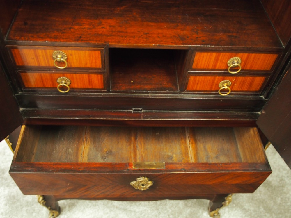A Louis XV style kingwood cabinet featuring geometric parquetry veneering, a red-toned marble top, two upper cabinet doors, three lower drawers, and gilt-bronze ormolu mounts. View IX