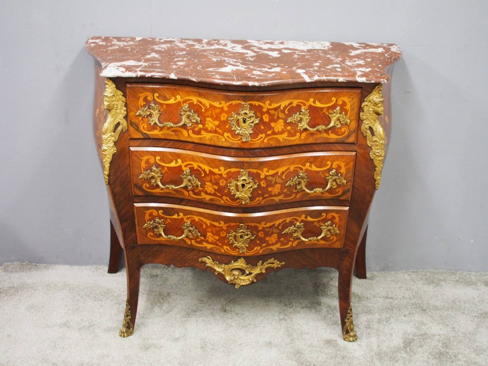 An antique French Louis XV style bombe commode crafted from kingwood marquetry with ornate ormolu mounts and a contoured marble top. View V
