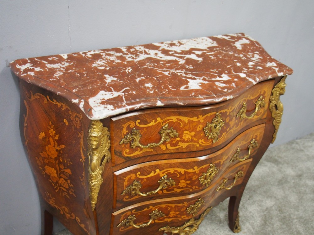 An antique French Louis XV style bombe commode crafted from kingwood marquetry with ornate ormolu mounts and a contoured marble top. View VI