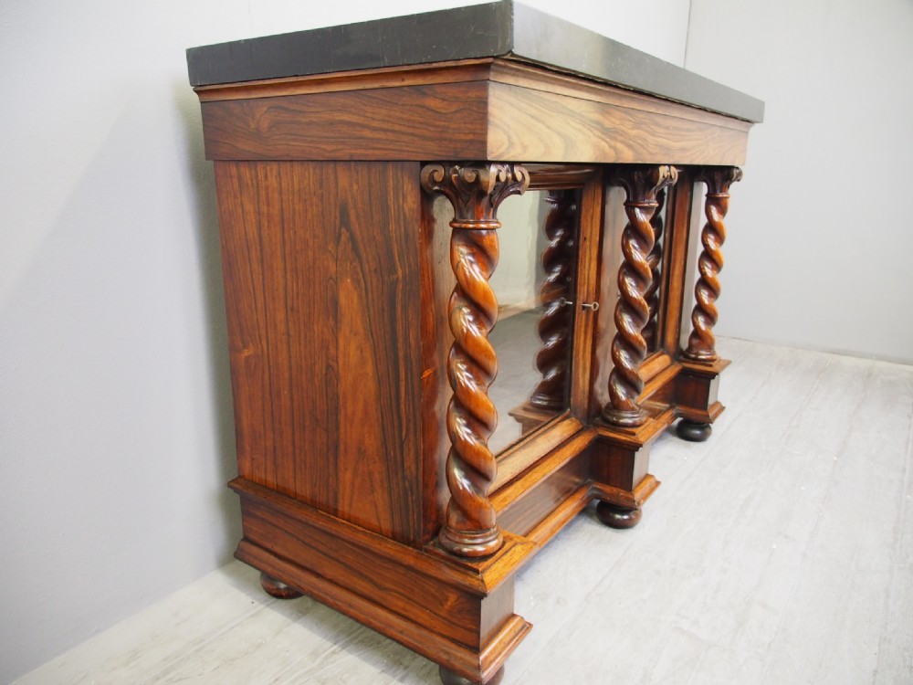 A dark William IV rosewood side cabinet featuring a geometric specimen marble top, barley twist support columns, and two glass door panels. View XIII