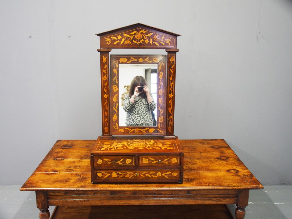 A Dutch marquetry toilet mirror with floral wood inlay, a pivoting rectangular frame, and a base featuring small drawers. View IV