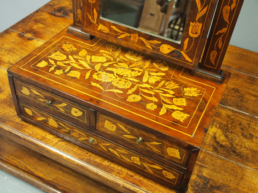 A Dutch marquetry toilet mirror with floral wood inlay, a pivoting rectangular frame, and a base featuring small drawers. View XI