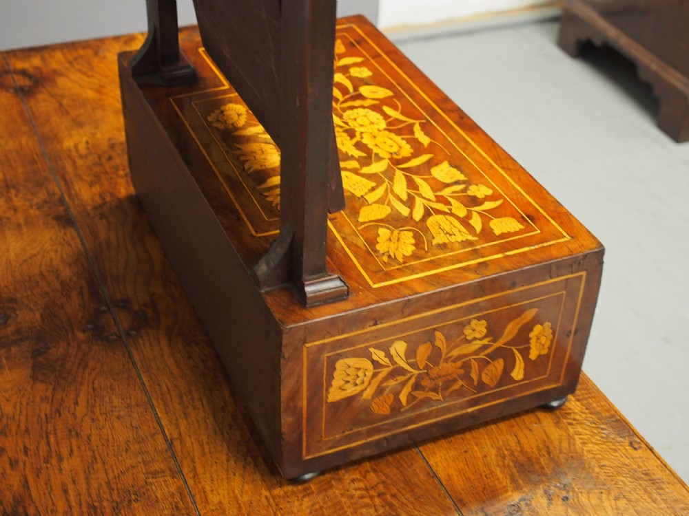 A Dutch marquetry toilet mirror with floral wood inlay, a pivoting rectangular frame, and a base featuring small drawers. View XV