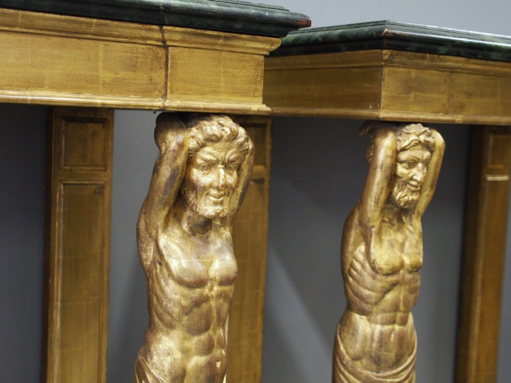 A pair of rectangular gilded console tables featuring carved mythological centaur figures supporting green marble tops. View VI