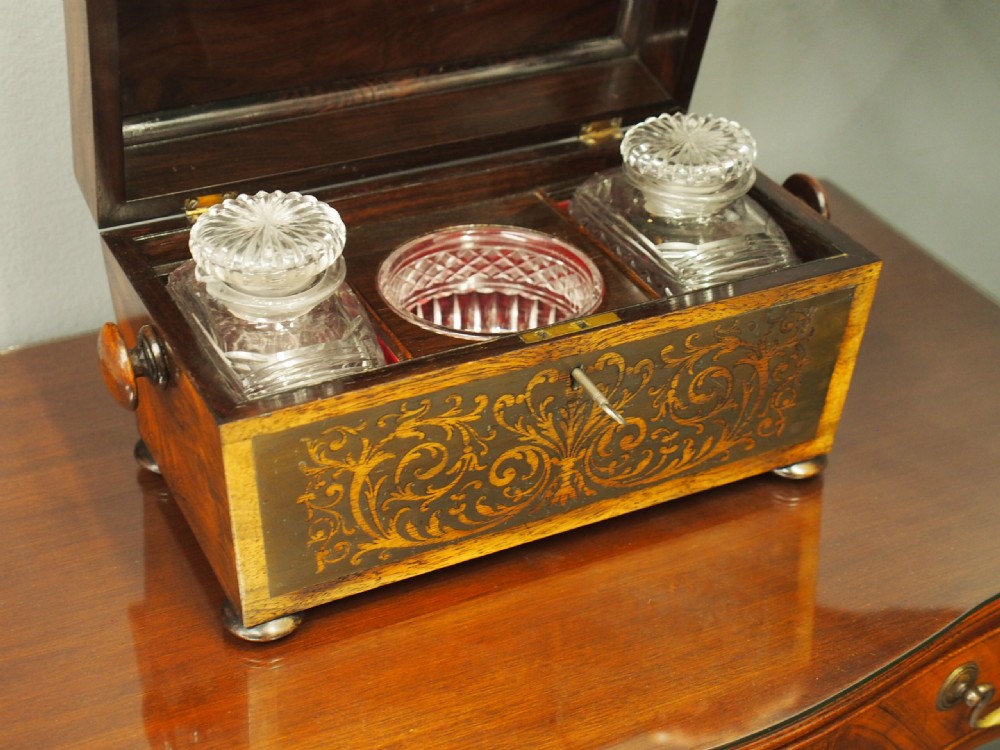 An antique dark rosewood tea caddy featuring intricate brass scrollwork inlay, side wooden ring handles, and turned bun feet. View VII