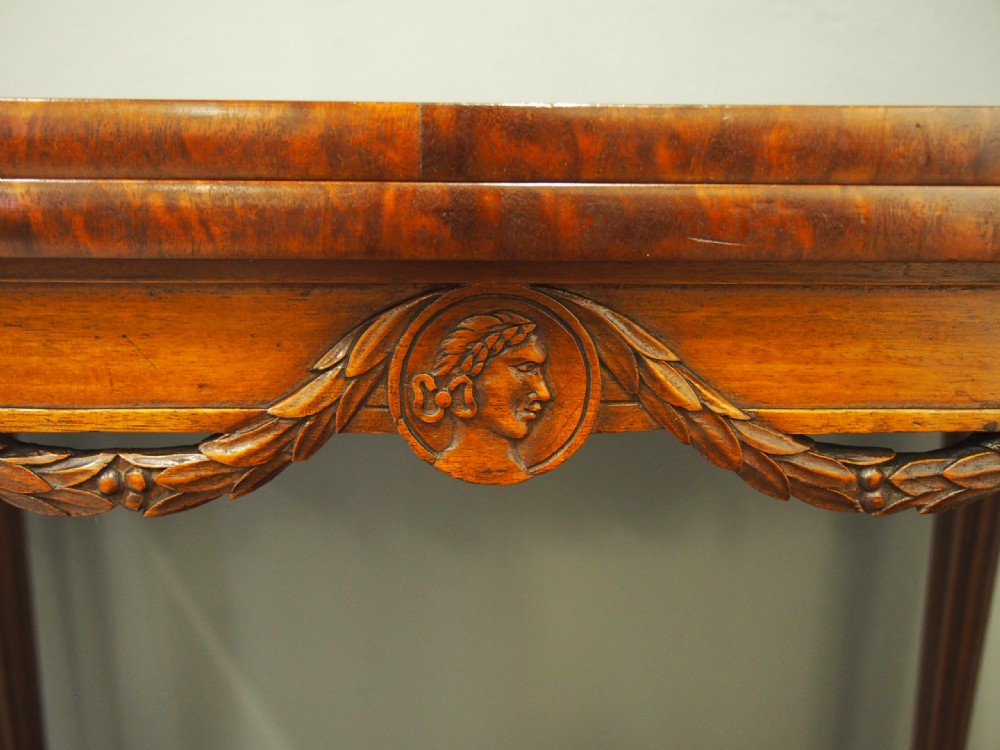 A pair of William IV mahogany foldover card tables featuring fluted legs, carved floral swags, and rectangular hinged tops. View X