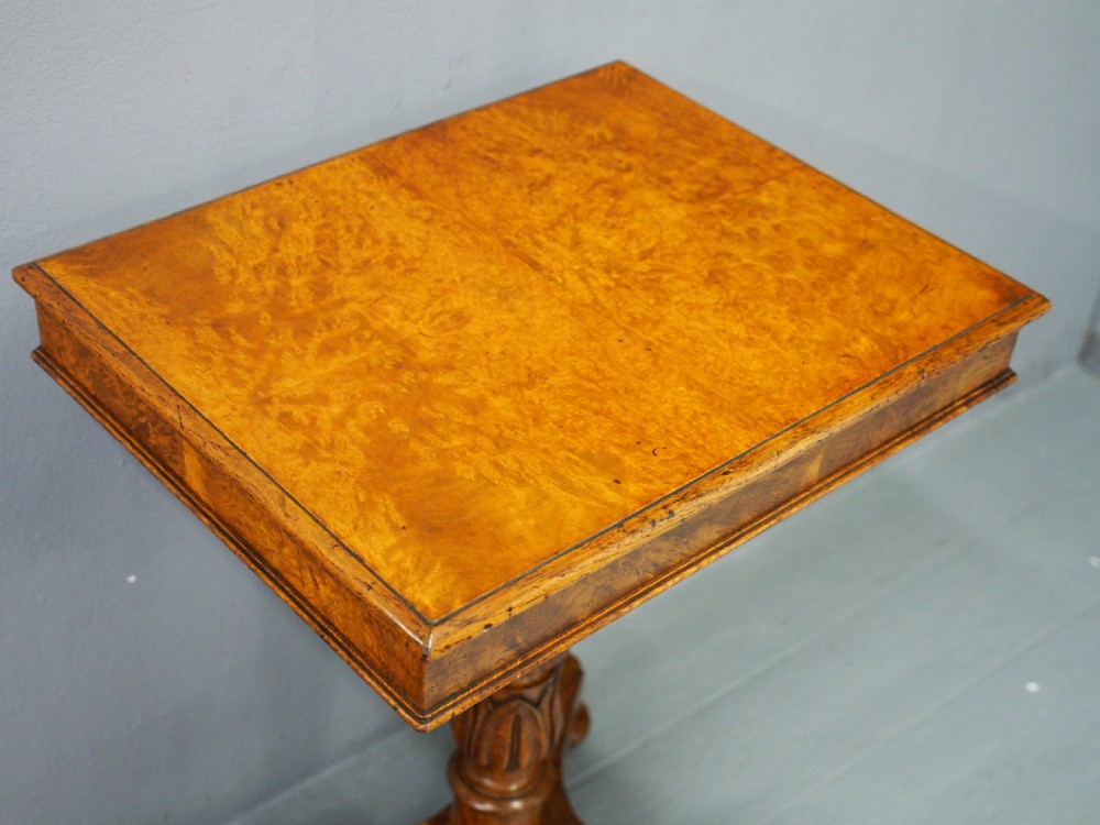 A William IV oak occasional table featuring a rectangular pollard oak top, a central carved stem, and a quadform base on bun feet. View IV