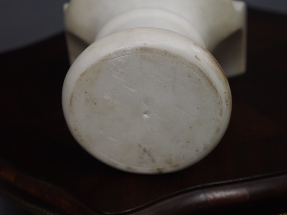 A white marble carved portrait bust depicting a gentleman with long flowing hair and period attire mounted on a round socle base. View VII