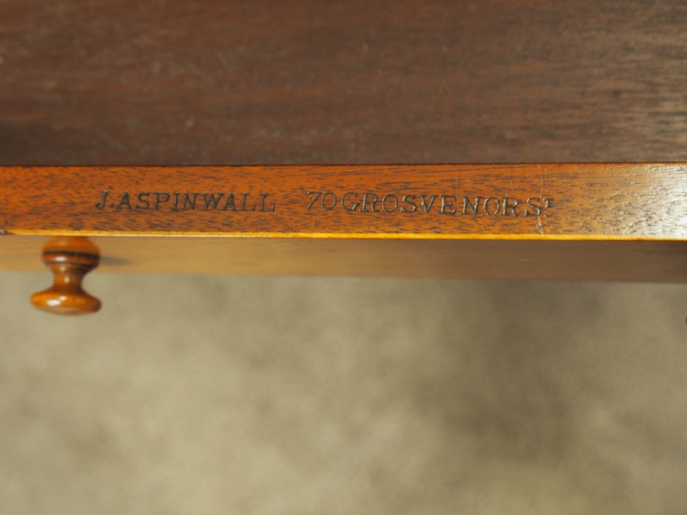 A Victorian satinwood work table featuring a carved top gallery, single drawer, pleated green silk work well, and carved trestle legs. View IV
