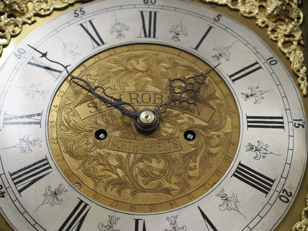 A tall Victorian mahogany longcase clock featuring a swan-neck pediment with fretwork, marquetry inlay, and a brass dial face. View XIII